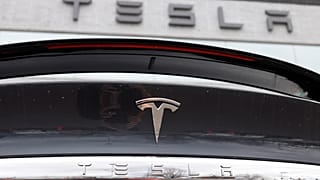 FILE - The Tesla company logo shines off the rear deck of an unsold 2020 Model X at a Tesla dealership, April 26, 2020, in Littleton, Colo. 