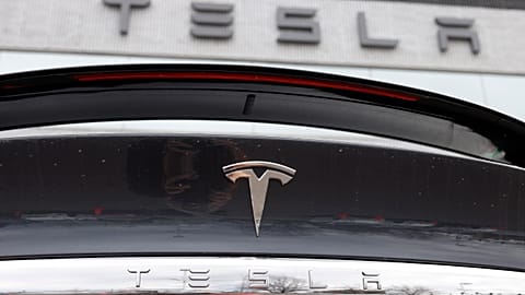 FILE - The Tesla company logo shines off the rear deck of an unsold 2020 Model X at a Tesla dealership, April 26, 2020, in Littleton, Colo. 