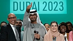 From left, UN Climate Chief Simon Stiell, COP28 President Sultan Al Jaber and Hana Al-Hashimi, chief COP28 negotiator for the United Arab Emirates, pose for photos at the end.