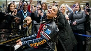 Alicia Keys plays on Elton John's piano at London's St Pancras train station