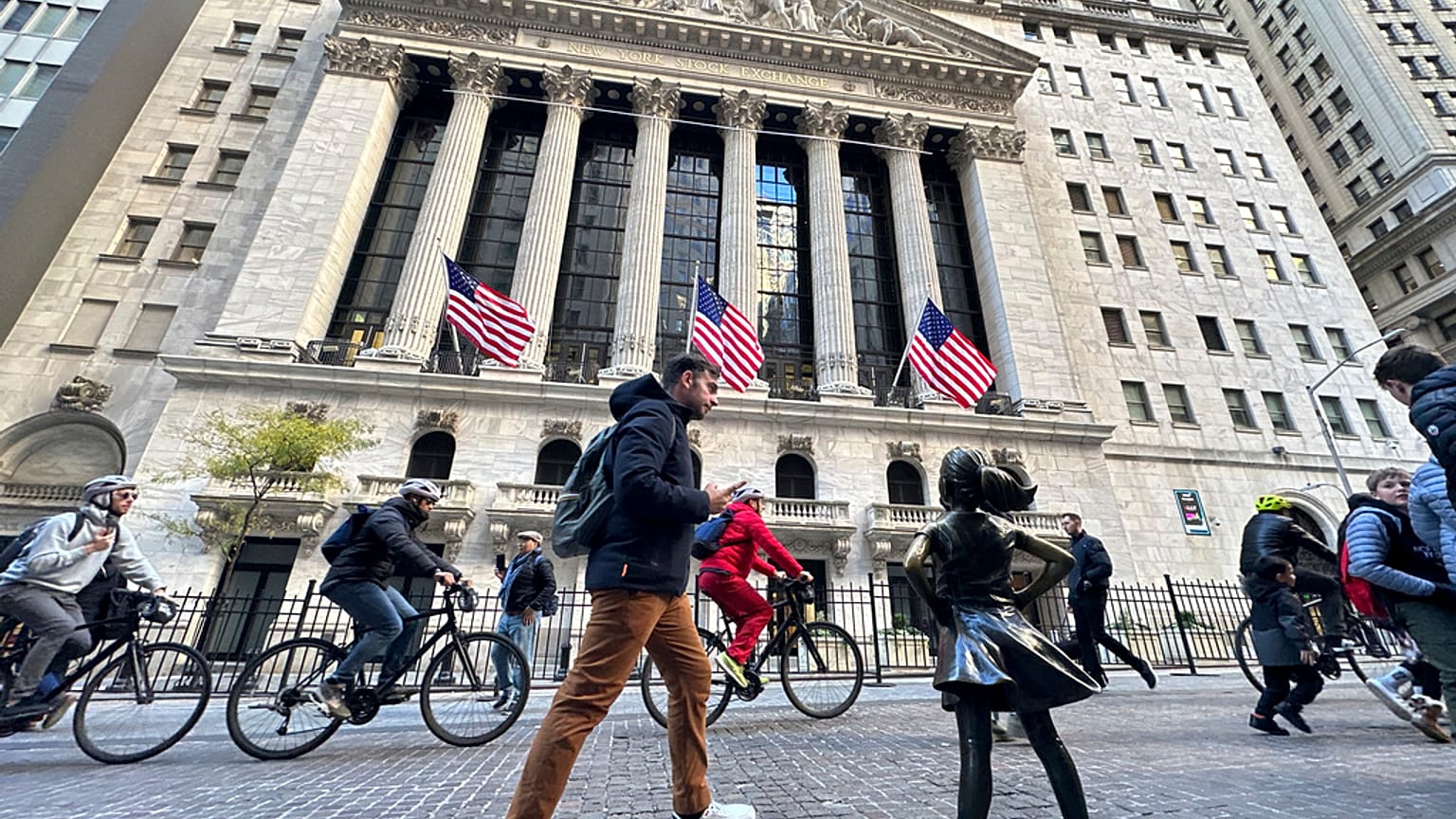 A man passes the "Fearless Girl" statue in front of the New York Stock Exchange in New York on Friday, November 3, 2023.