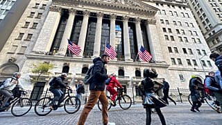 A man passes the "Fearless Girl" statue in front of the New York Stock Exchange in New York on Friday, November 3, 2023.