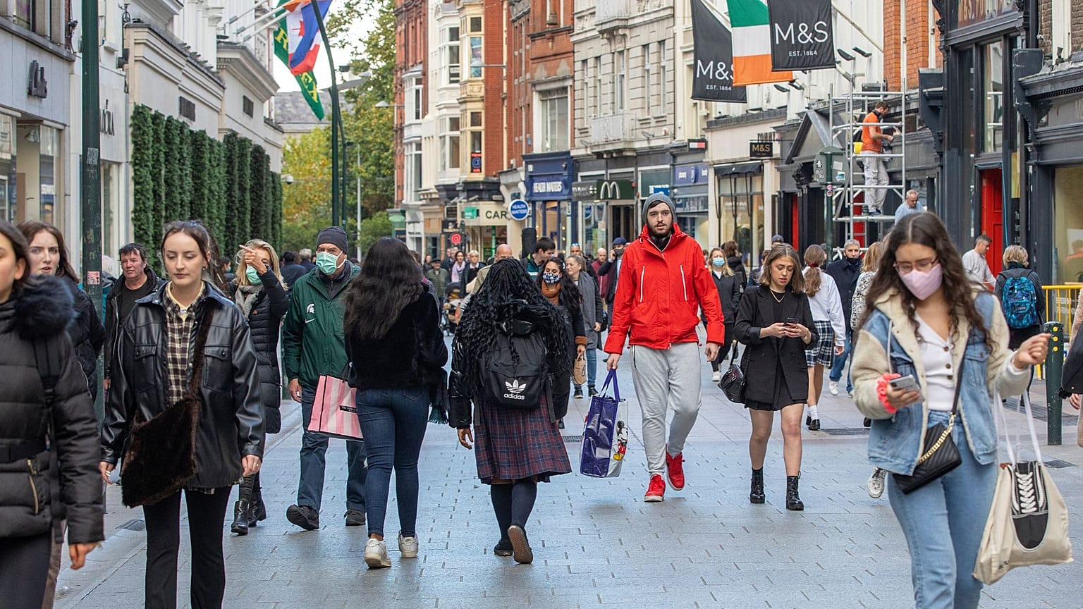 Shoppers walk through a busy Grafton Street in Dublin on October 21, 2020 
