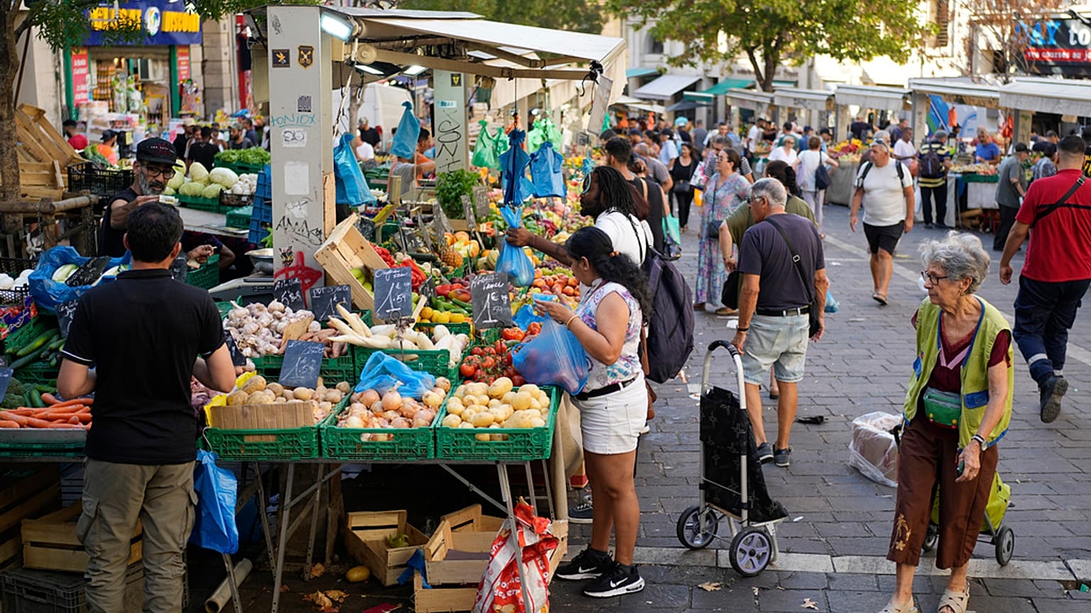 People shop at a street grocery market in Marseille, France, Thursday, Sept. 14, 2023.