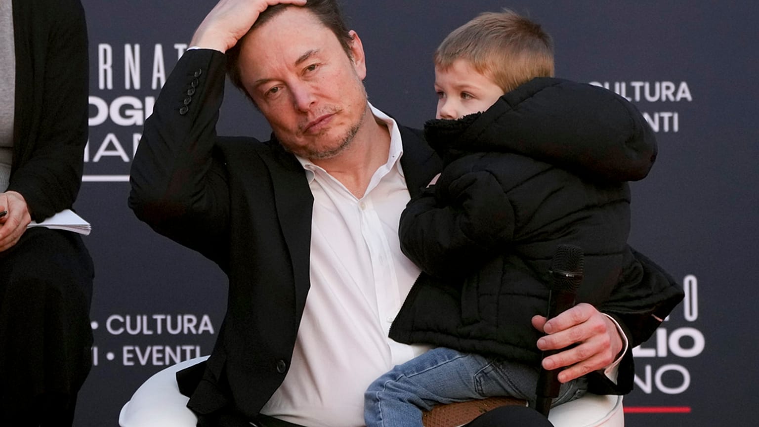 Tesla's CEO Elon Musk, holding his son, attends the annual political festival Atreju, organised by the Brothers of Italy political party, in Rome, December 16th 2023
