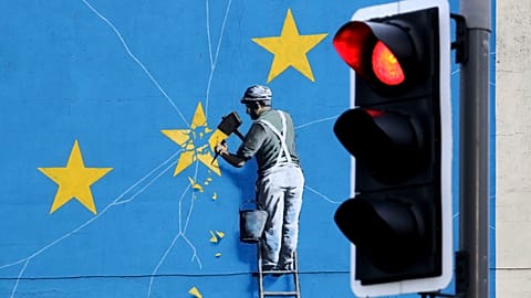 A view of the Banksy Brexit mural of a man chipping away at the EU flag in Dover, England, Tuesday, 11 December 2018.