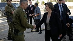 French Foreign Minister Catherine Colonna, right, is greeted by Israeli Col. Olivier Rafowicz as she arrives at the Shura military base, central Israel Sunday Dec. 17, 2023