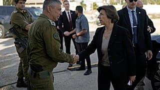 French Foreign Minister Catherine Colonna, right, is greeted by Israeli Col. Olivier Rafowicz as she arrives at the Shura military base, central Israel Sunday Dec. 17, 2023