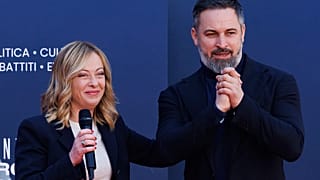 Leader of the Spanish far-right VOX party Santiago Abascal, right, stands on the stage with Italy's Prime Minister Giorgia Meloni during a Brothers of Italy party celebration