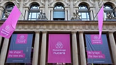 Banners with the logos of German industrial giant Thyssenkrupp and its hydrogen unit Nucera are seen on the facade of the Stock Exchange in Frankfurt am Main on July 7, 2023, 