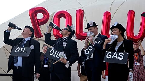 Activists protest against fossil fuels at the COP28 U.N. Climate Summit, Sunday, Dec. 10, 2023, in Dubai, United Arab Emirates.