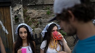 Revelers wearing bride costumes attend the Carmelitas street party in Rio de Janeiro, Brazil, Friday, Feb. 24, 2017. 