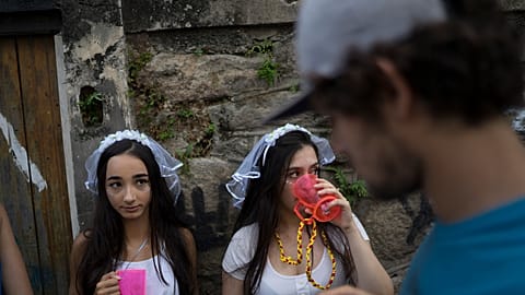 Revelers wearing bride costumes attend the Carmelitas street party in Rio de Janeiro, Brazil, Friday, Feb. 24, 2017. 
