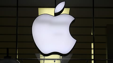 The Apple logo is illuminated at a store in the city center of Munich, Germany. Dec. 16, 2020.