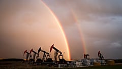 A rainbow appears to come down on pumpjacks drawing out oil and gas from wells near Calgary, Alberta, Monday, Sept. 18, 2023.