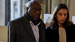Sosthene Munyemana, a Rwandan doctor, arrives at the Palais de Justice with his lawyer Florence Bourg 
