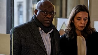 Sosthene Munyemana, a Rwandan doctor, arrives at the Palais de Justice with his lawyer Florence Bourg 