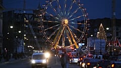 Traffic makes its way past a ferris wheel at one of the capital's many Christmas markets in front of the and the former east German parliament, the Palast der Republic, 06 Dec