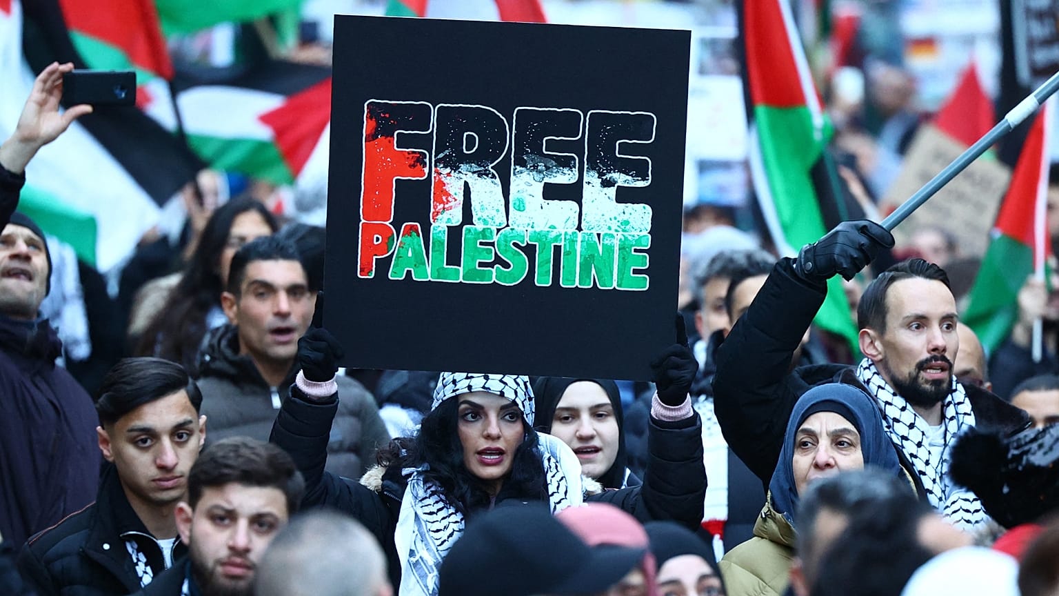 A demonstrator holds up a sign reading 'Free Palestine' during a rally in solidarity with Palestinians in Berlin, Germany, on November 18, 2023