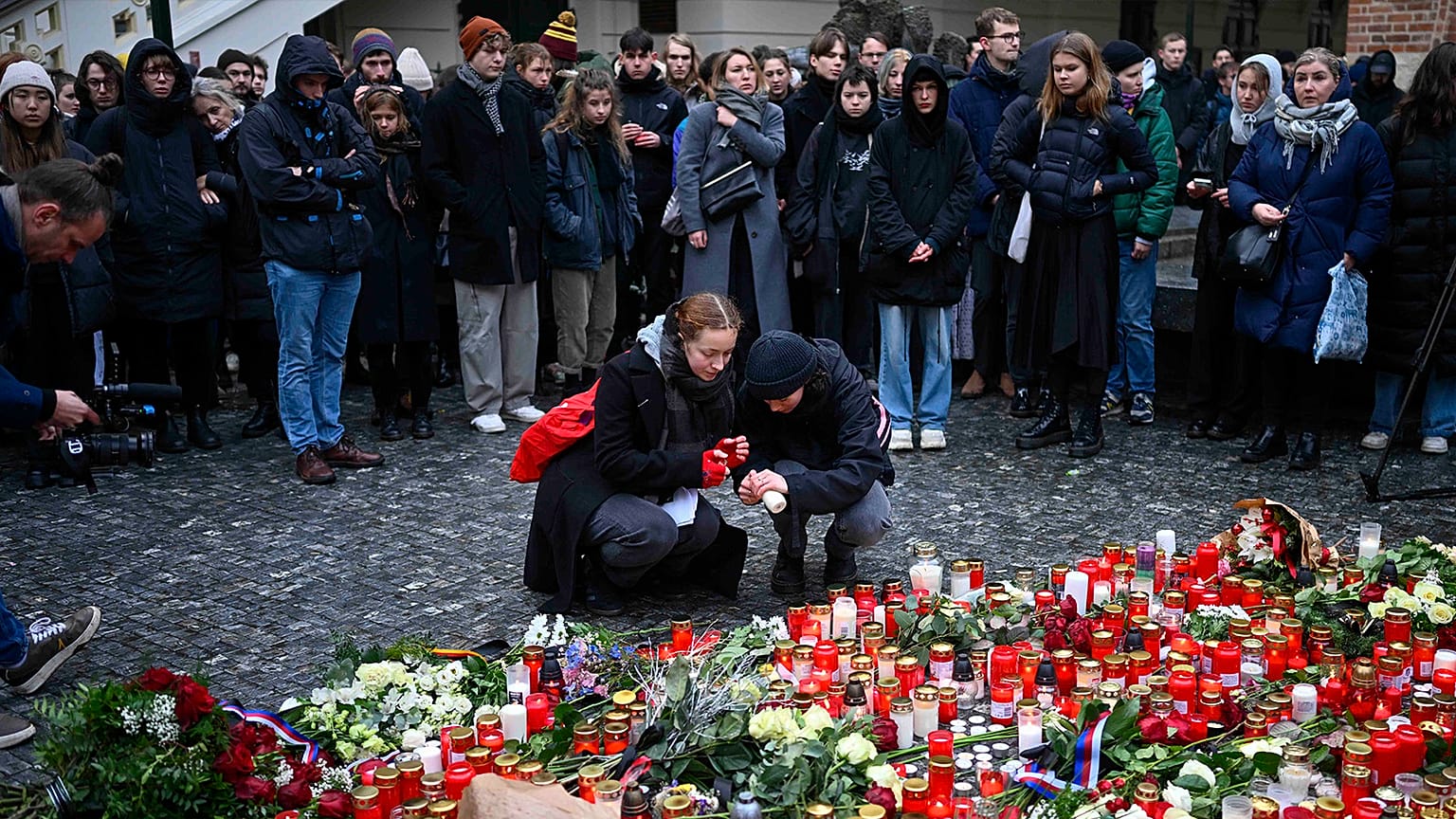 Mourners lay candle lights outside the headquarters of Charles University for victims of mass shooting in Prague, 22 December 2023
