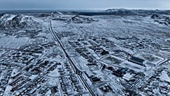 The lava field produced by the recent volcanic activity can be seen in the top background above Grindavik on Iceland's Reykjanes Peninsula, Thursday, Dec. 21, 2023.
