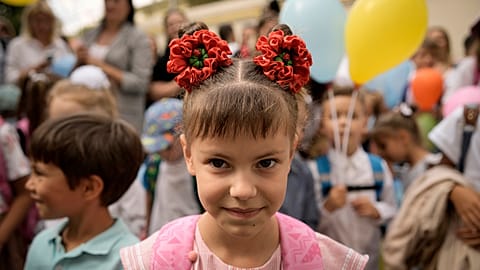 Ukrainian refugee children attend a ceremony marking the beginning of the school year at the Ienachita Vacarescu Elementary School in Bucharest, September 2022