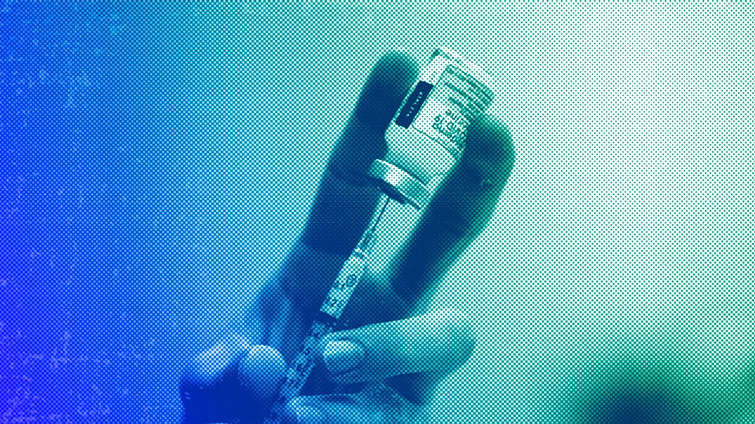 A dose of a Moderna COVID-19 vaccine is prepared, November 2021