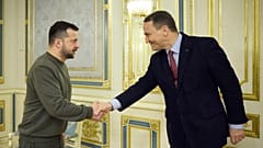  Ukrainian President Volodymyr Zelenskyy shakes hands with Poland's Minister of Foreign Affairs Radek Sikorsk in Kyiv, 22 December 2023
