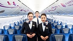 Members of the aircraft crew pose for photographs inside the Chinese-made C919 at the Hong Kong International Airport