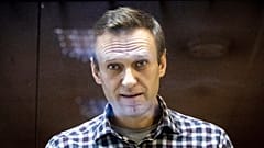 Russian opposition leader Alexei Navalny looks at photographers from inside a glass cage in the Babuskinsky District Court in Moscow, Russia, on Feb. 20, 2021