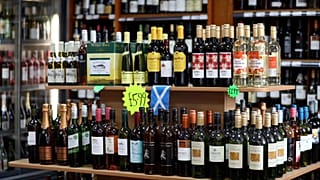 Shelves of alcoholic drinks are displayed for sale in an Edinburgh off-licence.