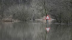 A photo taken on December 27, 2023 shows a traffic sign at the flooded Lippe river in Hamm, western Germany.