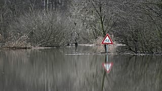 A photo taken on December 27, 2023 shows a traffic sign at the flooded Lippe river in Hamm, western Germany.