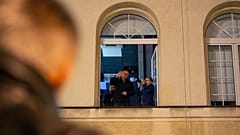 Journalist and protest leader Michal Adamczyk waves to a crowd of protesters at the TVP Info office in Warsaw after staff at public media institutions were dismissed