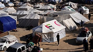 فلسطينيون نزحوا بسبب القصف الإسرائيلي على قطاع غزة ينصبون خيمًا في دير البلح