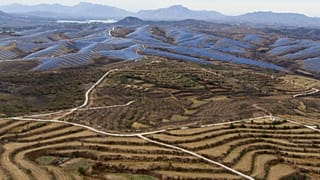 A solar farm operates next to Donggou village in the northern China's Hebei province, 10 November 2023.