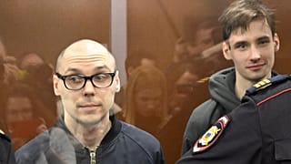 Russian poets Artyom Kamardin (L) and Yegor Shtovba (R) stand inside the defendants' glass cage during their verdict announcement at a court in Moscow on December 28, 2023.