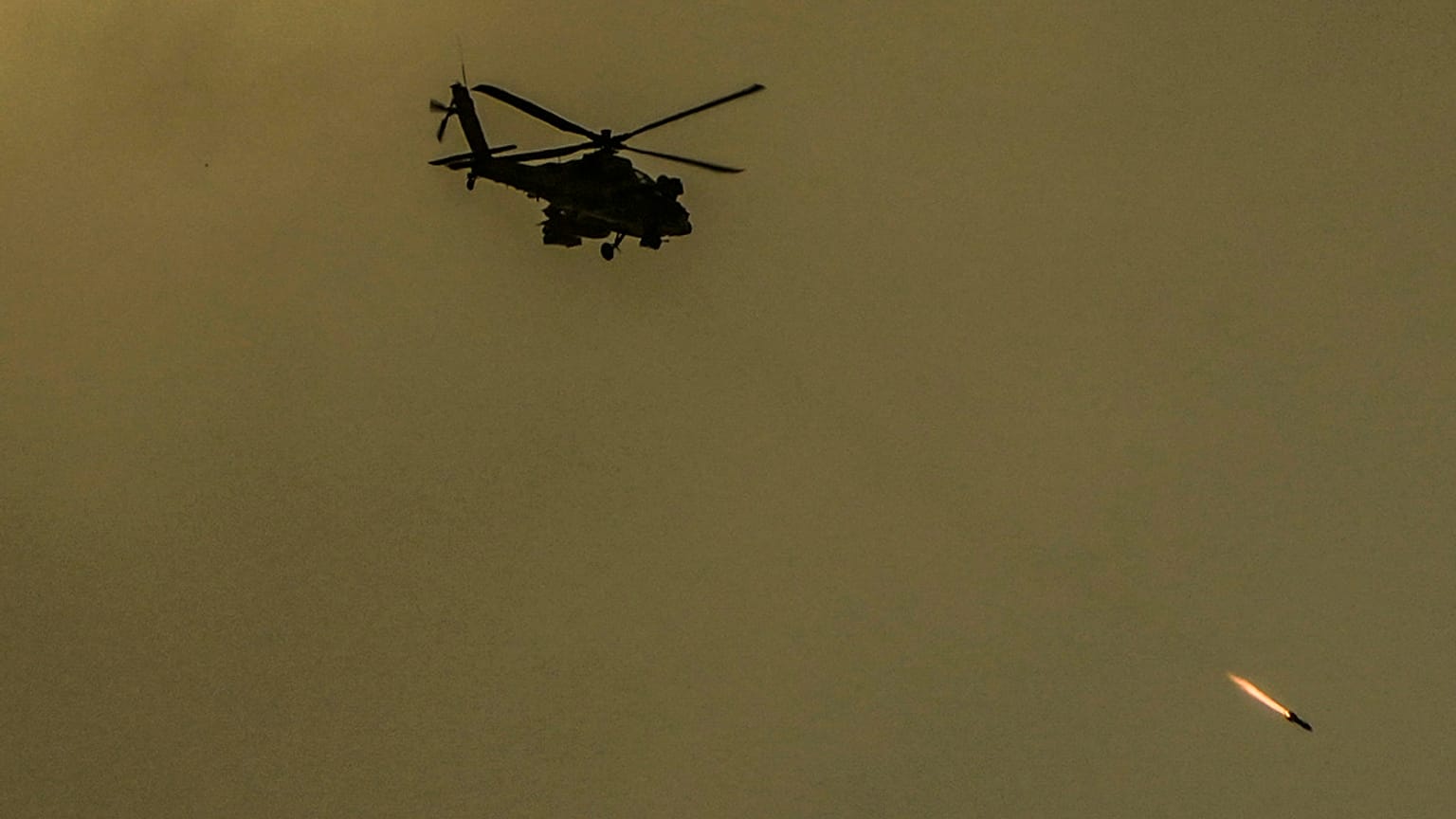 An Israeli Apache helicopter fires a missile in direction of the Gaza Strip, as seen from southern Israel, Friday, Dec. 29, 2023. 