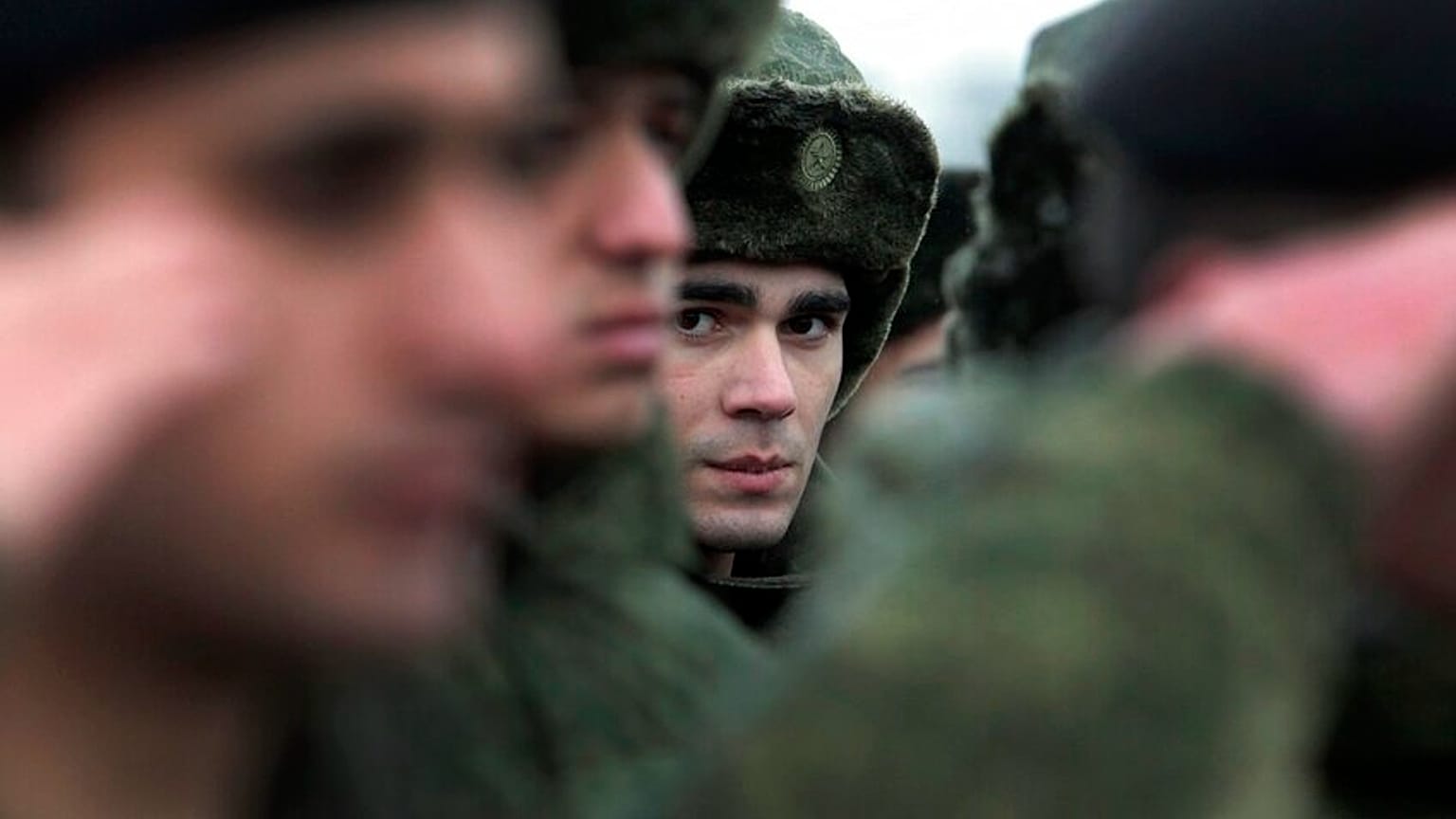 FILE - In this Monday, Nov. 17, 2014, file photo, conscripts stand at a military conscription office in Grozny, Chechnya's provincial capital.