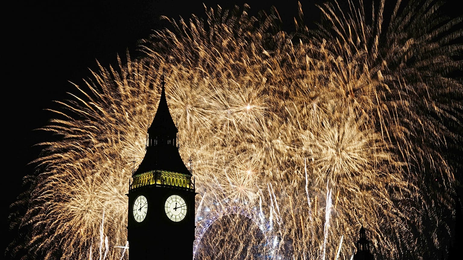 Fuochi d'artificio illuminano il cielo sopra al Big Ben e al London Eye, nel centro di Londra durante i festeggiamenti per il nuovo anno,1 gennaio 2024
