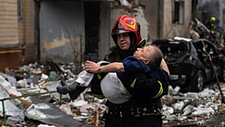 A firefighter carries a man from a damaged residential building after a Russian missile strike, in Kyiv, Ukraine, Tuesday, Jan. 2, 2024.