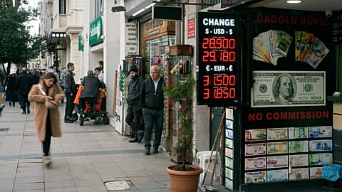 Peple walk next to an exchange currency shop in Istanbul, Turkey, Thursday, Dec. 21, 2023. Turkey's central bank hiked its key interest rate by 2.5 percentage points on Thursd