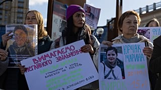People hold the posters "Freedom to civilian prisoners" while attending a meeting in support of civilian women imprisoned by Russia, on Independence square in Kyiv, Ukraine