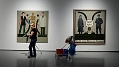 Two works by Polish artist Ignacy Czwartos on display at a 2021 exhibition. The painting on the right reads “German Mothers, German Fathers, Death Is A Master From Germany".