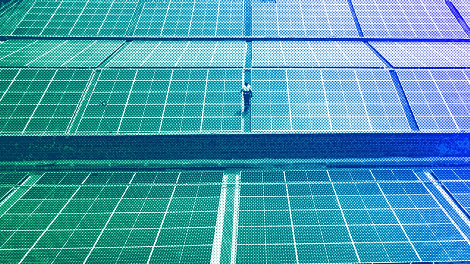 A technician examines solar panels on the roof of a company in Nairobi, September 2023