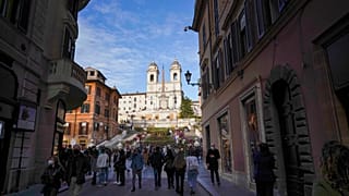 People walk on the Spanish Steps decorated with flowers, in downtown Rome, Saturday, April 17, 2021.