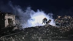 Ukrainian Emergency Service, firefighters examine the site of Russia's missile attack that hit an apartment building in Pokrovsk, Ukraine, late Saturday, Jan. 6, 2024.