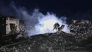 Ukrainian Emergency Service, firefighters examine the site of Russia's missile attack that hit an apartment building in Pokrovsk, Ukraine, late Saturday, Jan. 6, 2024.
