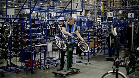 Brompton folding bicycles are assembled by hand at the Brompton factory in west London, Tuesday, Nov. 24, 2020. 