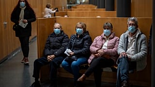 People wearing face masks as a precaution wait for a doctor appointment inside a hospital in Barcelona, Spain, Monday, 8 January, 2024.